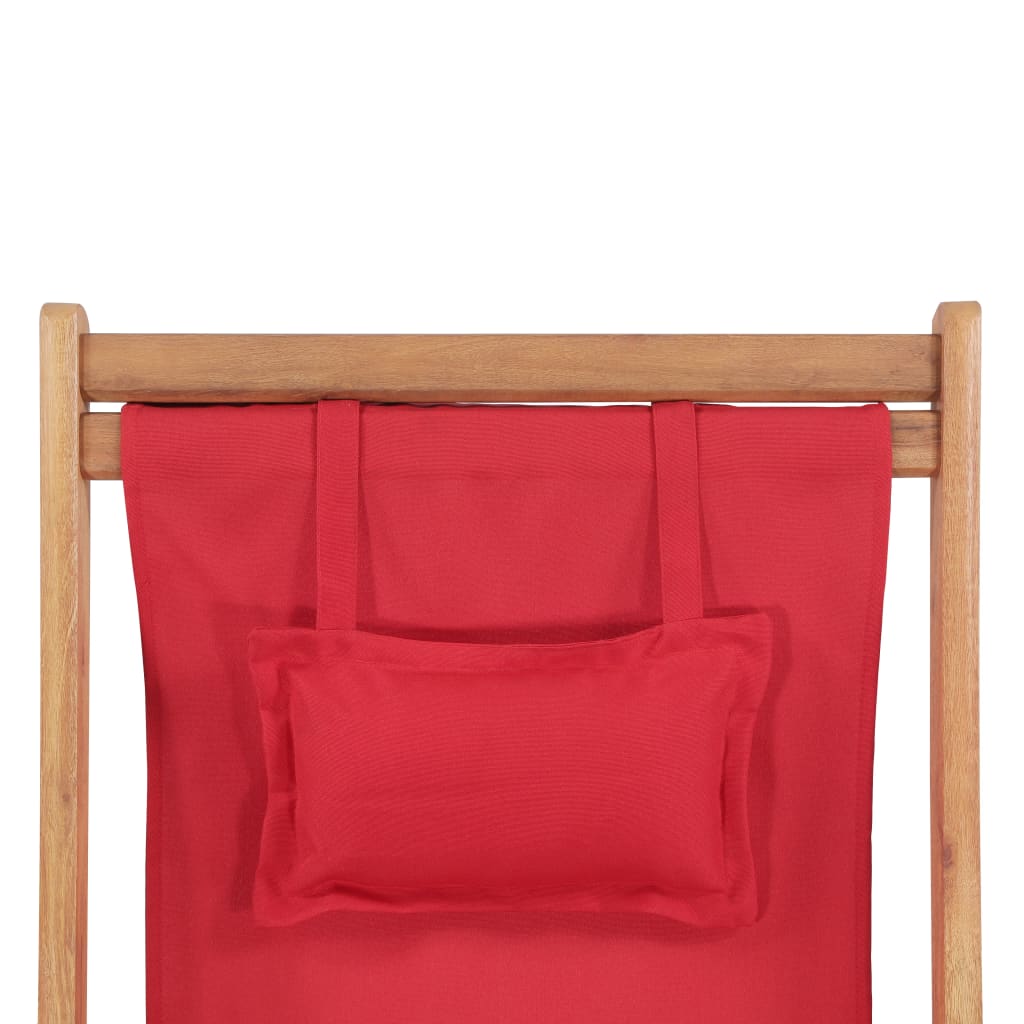 Top view of a red folding beach chair with wooden frame and a small cushion for added comfort.