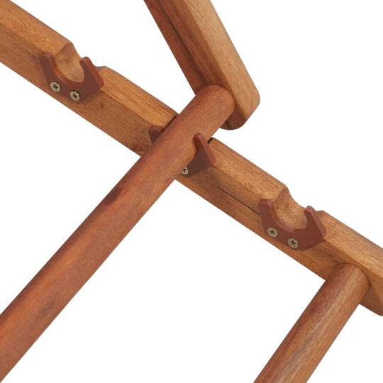 Close-up of the sturdy wooden frame of a folding beach chair, highlighting its durable connectors and construction.